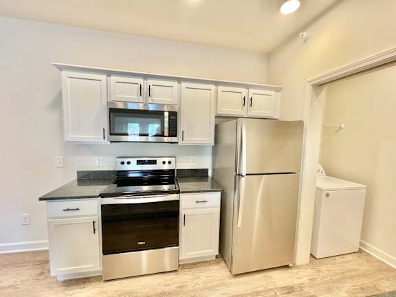 A kitchen with a stainless steel refrigerator, oven, and microwave.at Concord Crossing, Lafayette, 47909