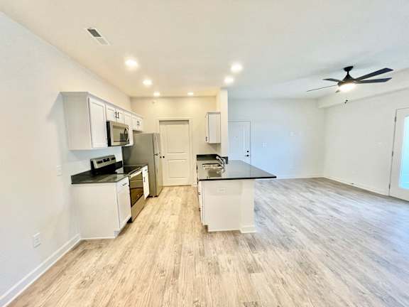 A kitchen with white cabinets and a black countertop.at Concord Crossing, Lafayette, 47909