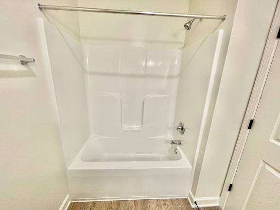 A white bathroom with a tub and shower.at Concord Crossing, Indiana