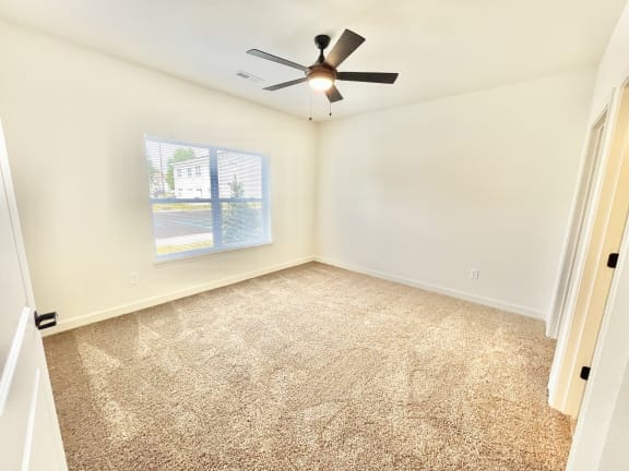 an empty room with a ceiling fan and a window at Murdock Gardens Apartments, Lafayette, IN 47904
