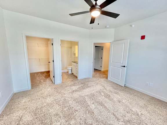 A room with a ceiling fan and carpeted floor.at Concord Crossing, Lafayette Indiana