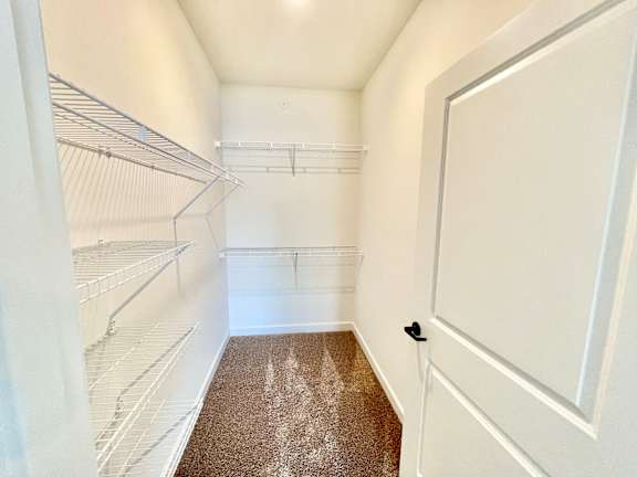 A white refrigerator with a brown carpet in front of it.at Concord Crossing, Indiana, 47909