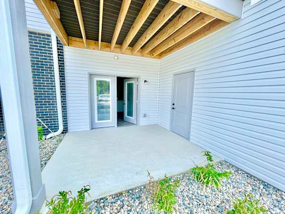 A concrete patio area with a doorway leading to another room.at Concord Crossing, Indiana