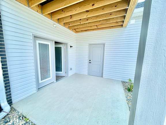 A patio area with a door and a window.at Concord Crossing, Lafayette, 47909