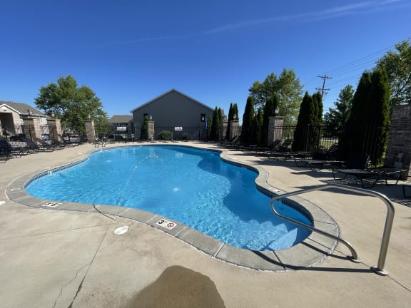 our resort style swimming pool is in front of our house and has chairs around it at Hawthorne Properties in Lafayette, IN 47905