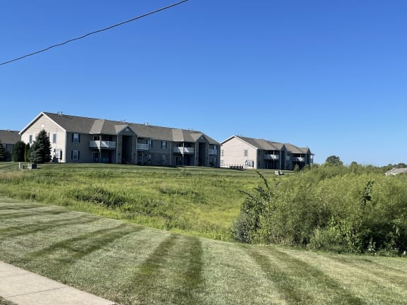 a row of houses on a hill with a blue sky at Hawthorne Properties in Lafayette, IN 47905