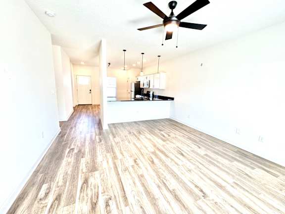 A room with a ceiling fan and wooden flooring.at Concord Crossing, Indiana, 47909