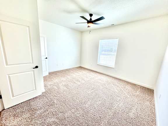 A room with a carpeted floor and a ceiling fan.at Concord Crossing, Lafayette, IN 47909