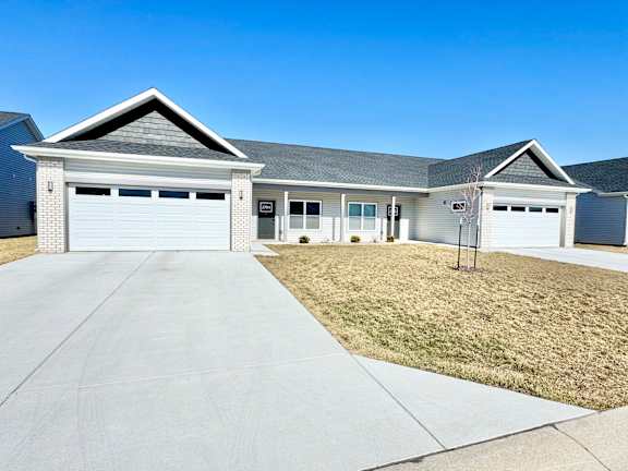A two-car garage is attached to a house.at Concord Crossing, Indiana, 47909