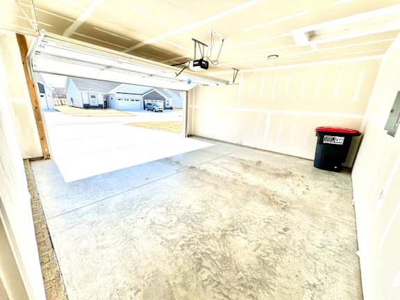 A large empty garage with a black trash can.at Concord Crossing, Lafayette Indiana