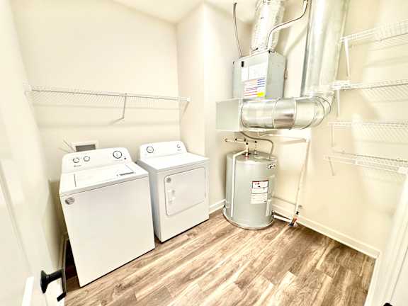 A laundry room with a washer and dryer and a water heater.at Concord Crossing, Indiana, 47909