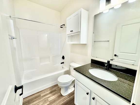 A white bathroom with a sink, toilet, and a shower.at Concord Crossing, Lafayette Indiana