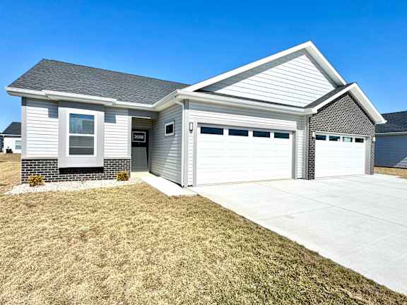 A house with a grey roof and a white garage door.at Concord Crossing, Lafayette, IN 47909