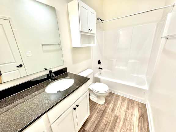 A bathroom with a sink, toilet, and bathtub.at Concord Crossing, Indiana