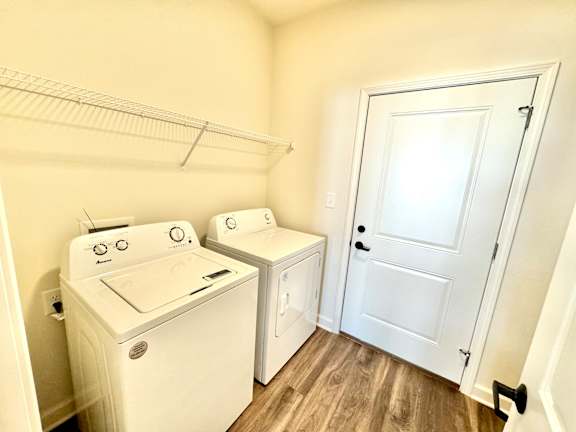 A small laundry room with a washer and dryer.at Concord Crossing, Lafayette Indiana