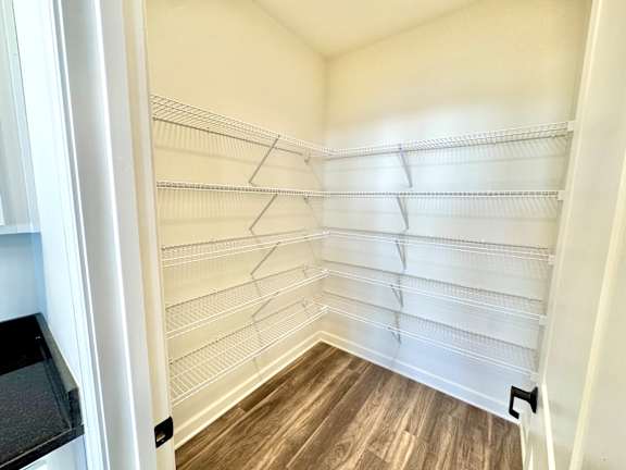 Empty white shelves in a room with wood flooring.at Concord Crossing, Lafayette