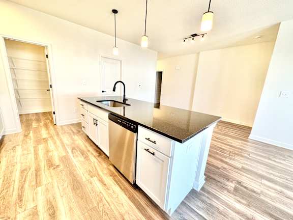 A kitchen with a sink, stove, and cabinets.at Concord Crossing, Lafayette, IN