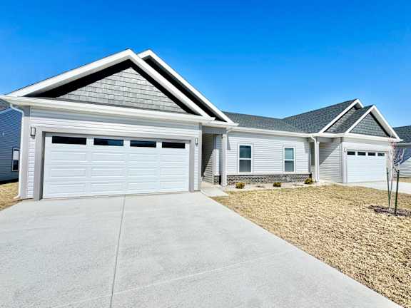 A duplex with a garage is shown.at Concord Crossing, Indiana, 47909