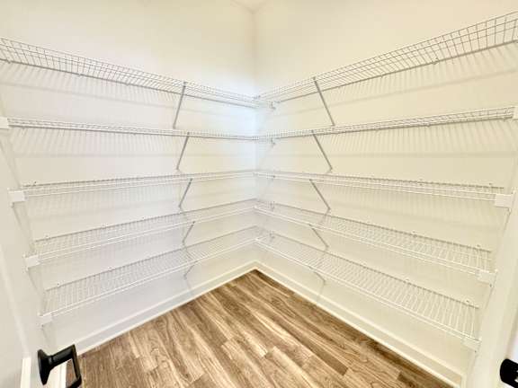 Empty white shelves in a room with wooden flooring.at Concord Crossing, Lafayette, IN