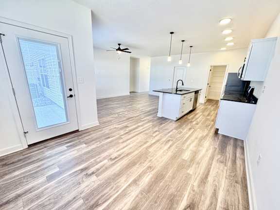 A spacious kitchen with a white countertop and a ceiling fan.at Concord Crossing, Lafayette, IN 47909
