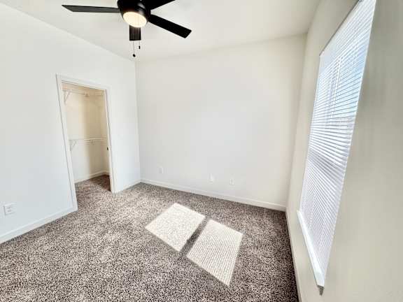 A room with a ceiling fan and carpeted floor.at Concord Crossing, Lafayette, IN 47909