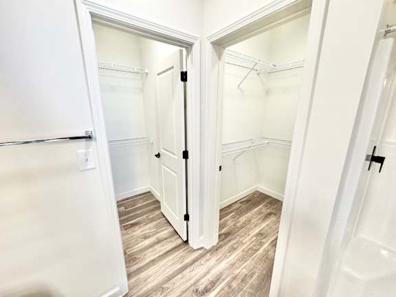 A white closet with a wooden floor and a white door.at Concord Crossing, Indiana, 47909