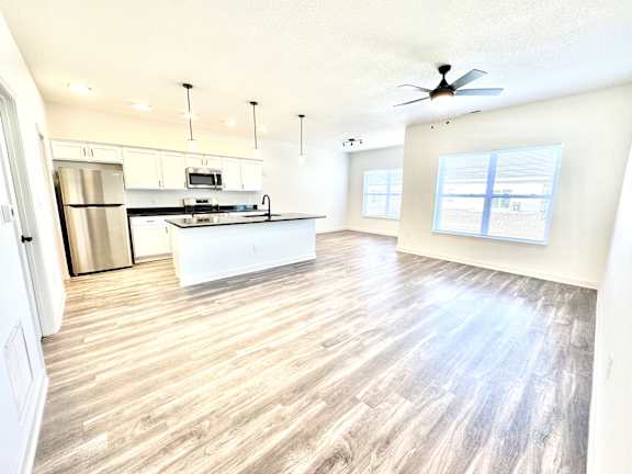 A spacious kitchen with a refrigerator, microwave, and oven.at Concord Crossing, Lafayette, 47909