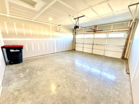 A spacious garage with a concrete floor and a white ceiling.at Concord Crossing, Lafayette, IN 47909