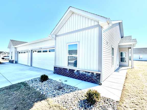 A modern house with a white exterior and a grey roof.at Concord Crossing, Lafayette, IN 47909