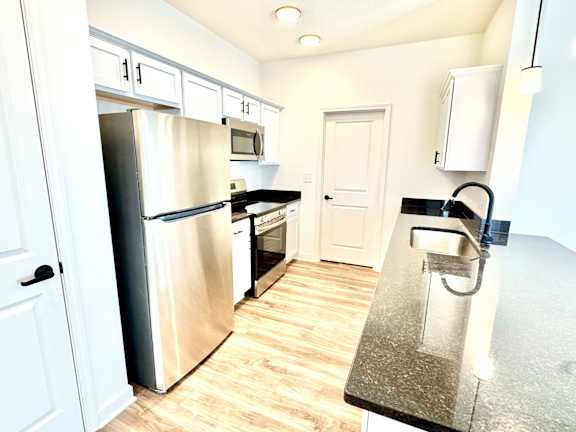 A kitchen with a stainless steel refrigerator and microwave.at Concord Crossing, Lafayette, 47909