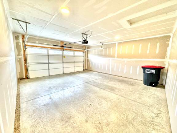A large empty garage with a red and black trash can.at Concord Crossing, Lafayette