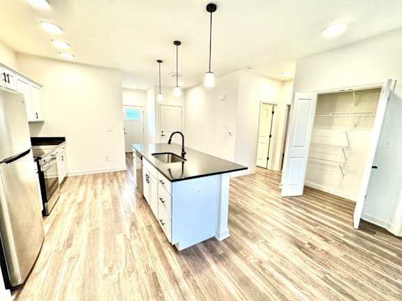 A kitchen with black countertops and white cabinets.at Concord Crossing, Lafayette, IN 47909