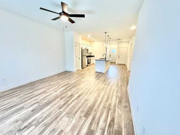 A room with a ceiling fan and wooden flooring.at Concord Crossing, Indiana, 47909