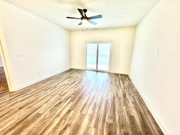A room with a ceiling fan and a window.at Concord Crossing, Lafayette, IN