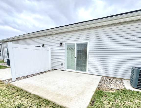 A house with a white garage door and a glass door.at Concord Crossing, Lafayette