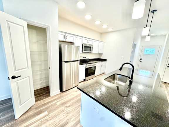 A kitchen with a granite countertop and stainless steel appliances.at Concord Crossing, Lafayette, IN