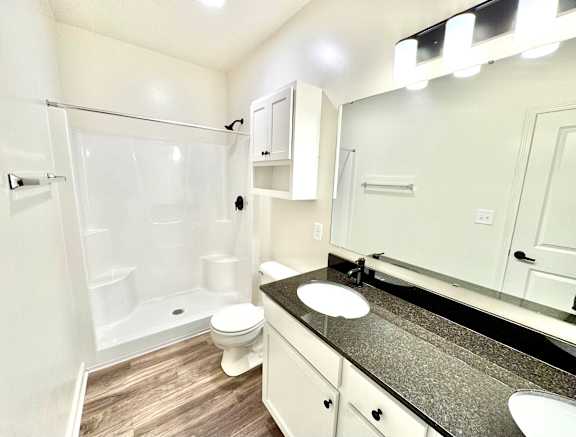A bathroom with a sink, toilet, and shower.at Concord Crossing, Lafayette Indiana