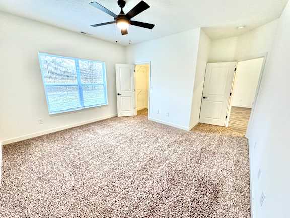 A room with a ceiling fan and carpeted floor.at Concord Crossing, Lafayette, IN 47909
