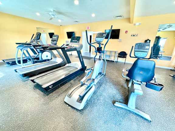 A gym with treadmills and exercise bikes.
