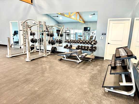 A gym with a variety of equipment including weights and benches.at Concord Crossing, Lafayette, 47909