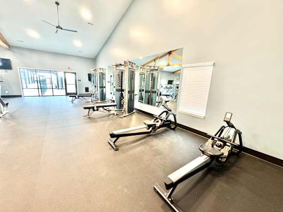 A gym with a variety of equipment including treadmills, weights, and a fan.at Concord Crossing, Indiana