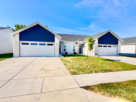 A two-story house with a garage door painted blue.