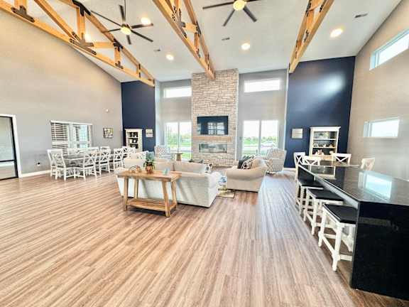 A spacious living room with a fireplace and a dining area.