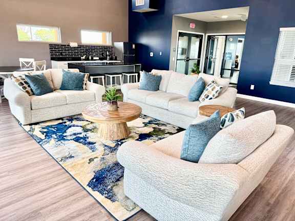 A living room with a white couch and a wooden coffee table.