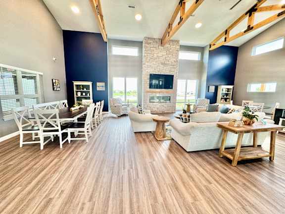 A living room with a fireplace and a dining table.