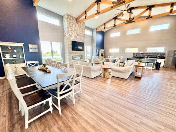 A modern dining room with a large table and chairs.