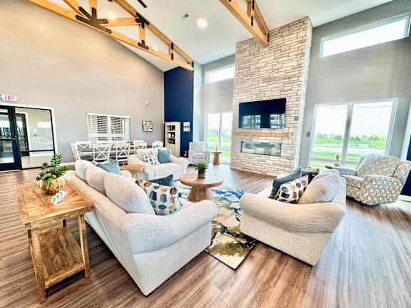 A living room with a fireplace and two couches.
