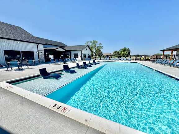 A large swimming pool with a 50-meter marking on the side.