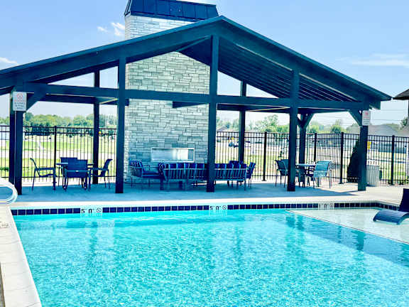 A pool with a glass divider and a black fence.