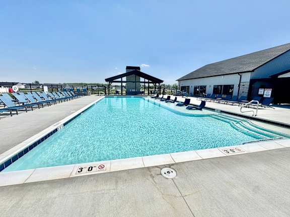A large outdoor swimming pool with a 3'0" depth marker.